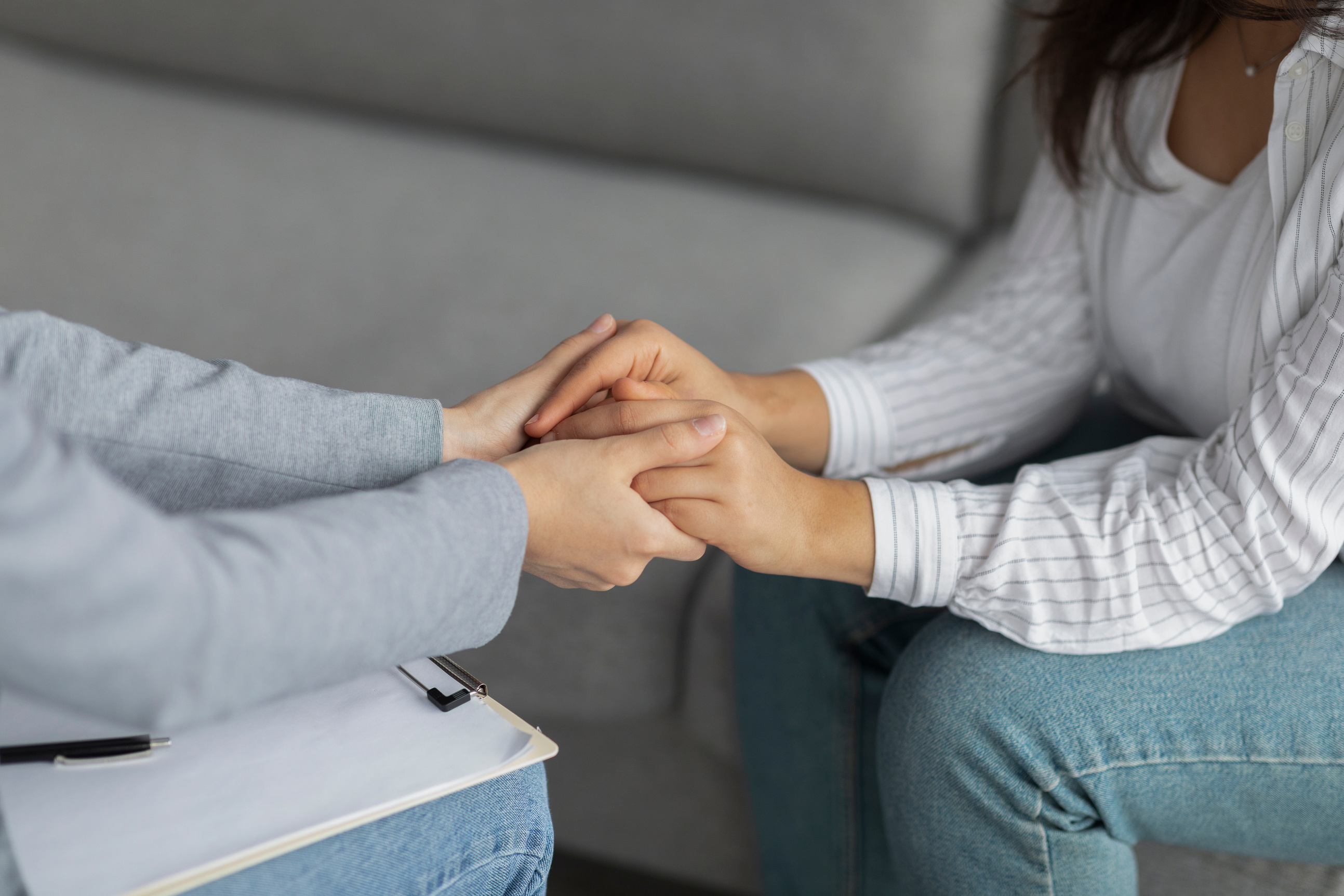 Professional Compassion. Psychotherapist Supporting Depressed Woman, Holding Her Hands, Sitting in Clinic, Cropped