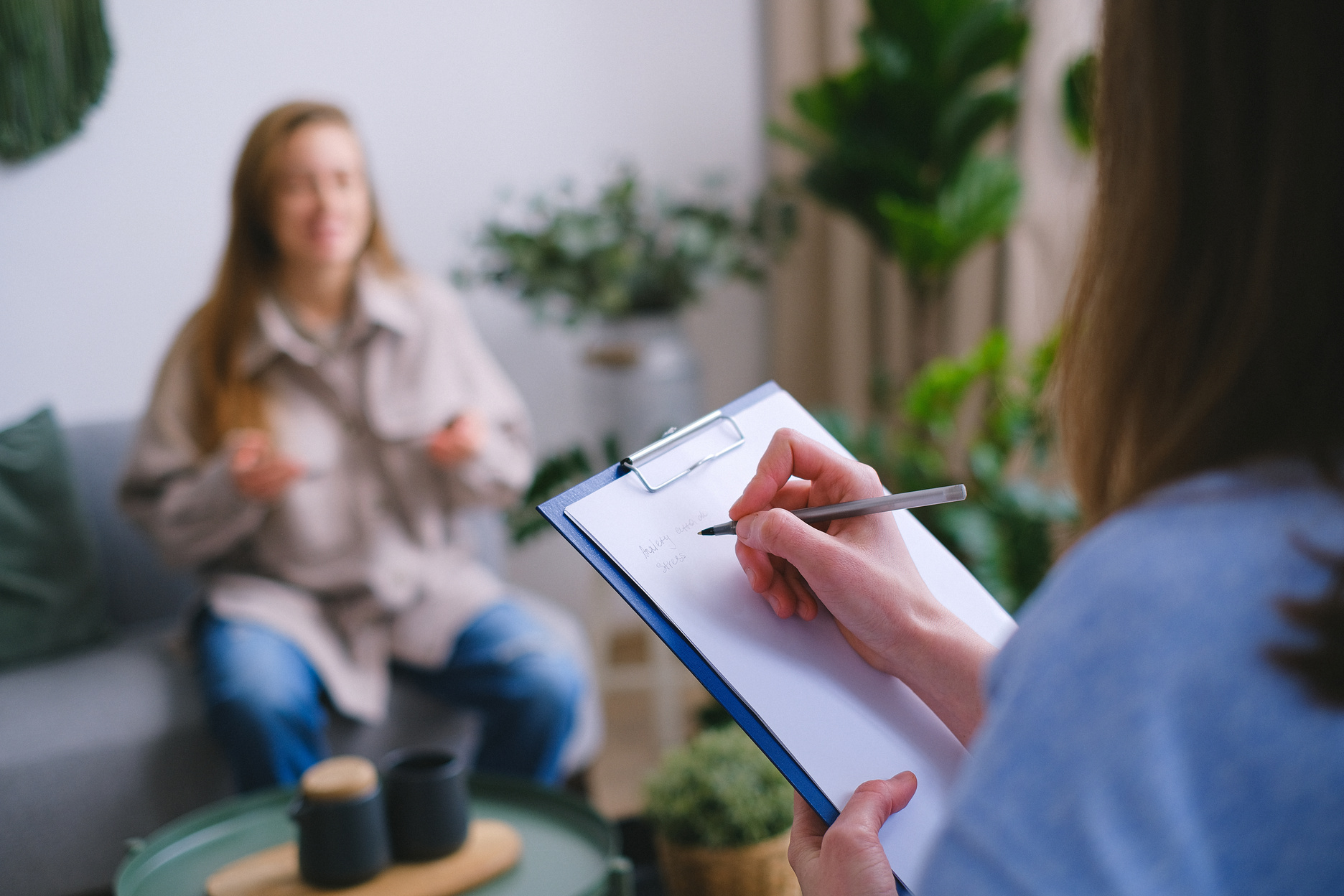 Crop psychologist taking notes during appointment